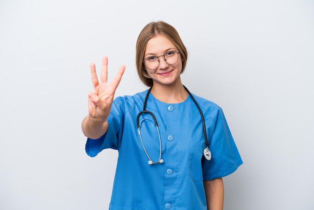 Young nurse doctor woman isolated on white background happy and counting three with fingers