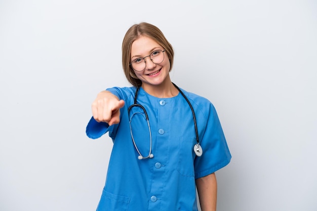 Young nurse doctor woman isolated on white background points finger at you with a confident expression