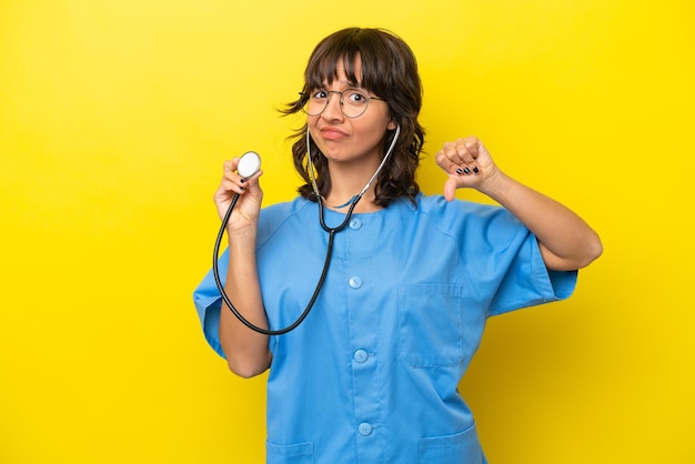 Young nurse doctor woman isolated on yellow background