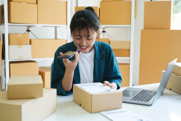 Young online business owner talking with customer on the phone