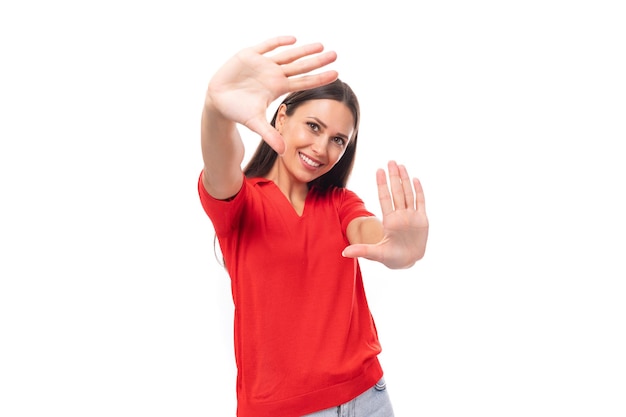 Young optimistic charming caucasian female model with black straight hair wearing a red short sleeve