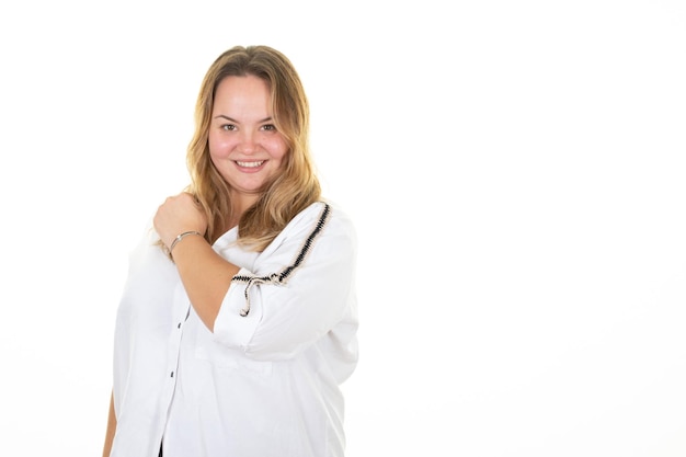 Young oversize blond pretty happy smiling woman with hand on shoulder on white background