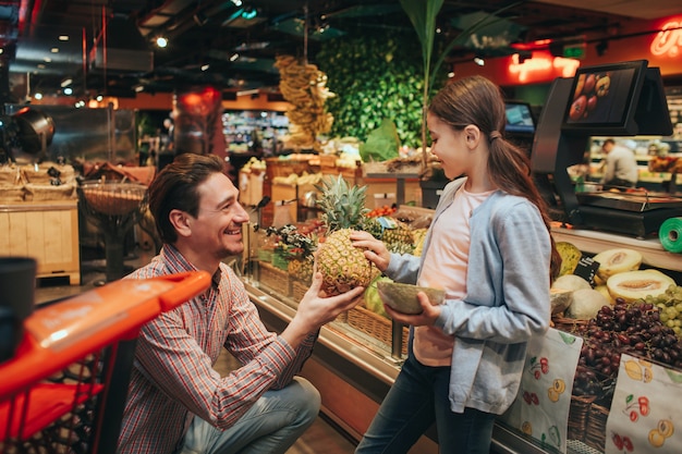 Young parent and daughter at grocery store