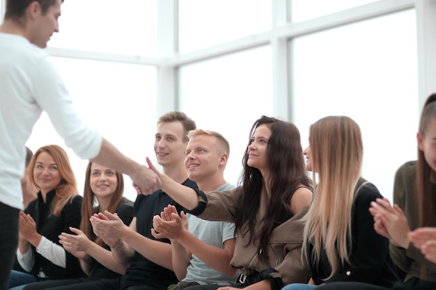 Young people applaud at a group meeting