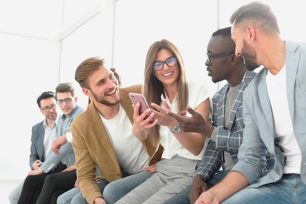 Young people of different nationalities are using gadgets talking and smilingpeople and technology