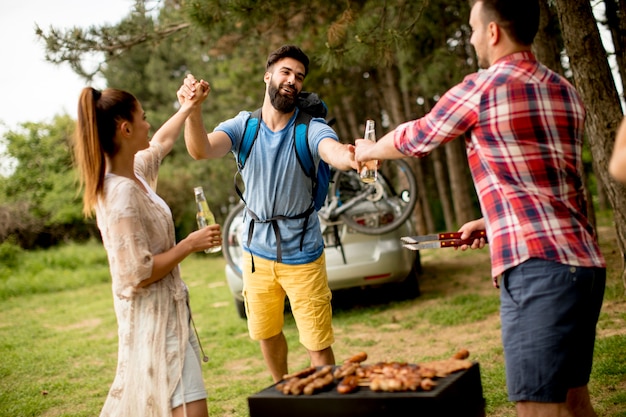 Young people enjoying barbecue party in the nature