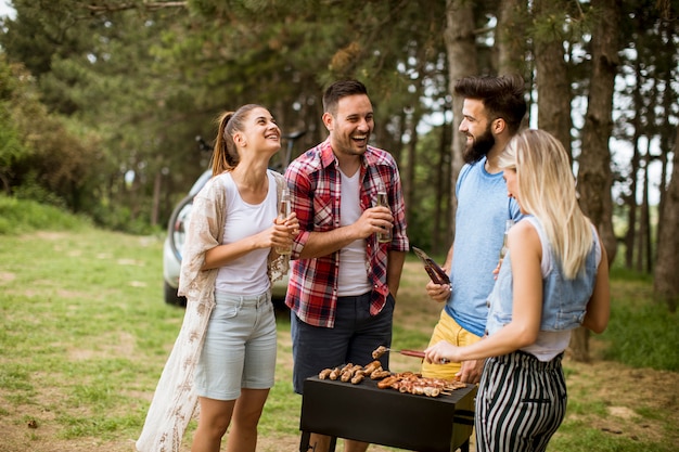 Young people enjoying barbecue party in the nature