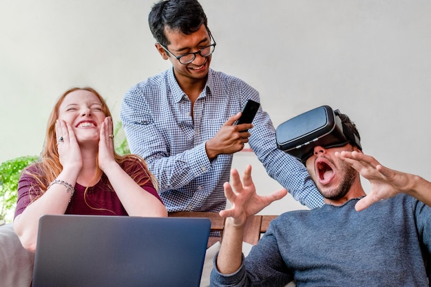 Young people having fun with new technology vr headset goggles, university students using a virtual reality game program