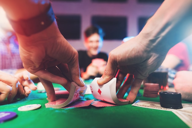 Young people play poker with alcohol 