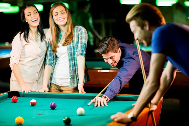 Young people playing pool