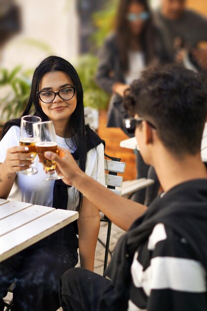 young people sharing a coffee, beer, smiling, talking, enjoying together, classmates, life partners,