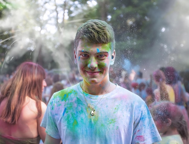 Young people teenagers and adults celebrate the Holi event in Ukraine in Chernivtsi on March 8 in 2022 They have fun and throw paint at each other