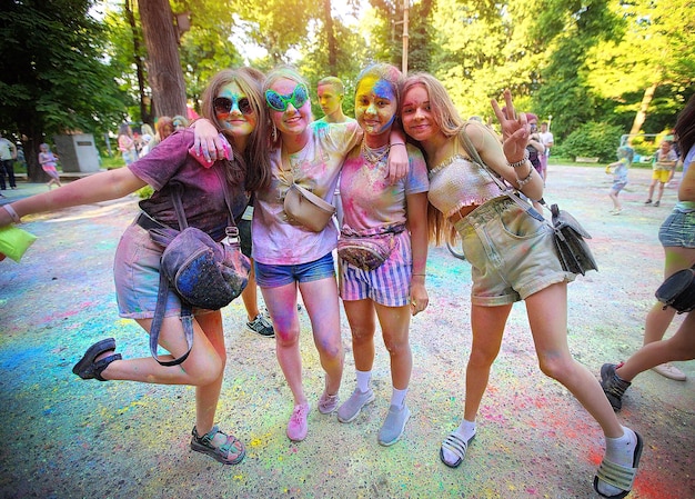 Young people teenagers and adults celebrate the Holi event in Ukraine in Chernivtsi on March 8 in 2022 They have fun and throw paint at each other