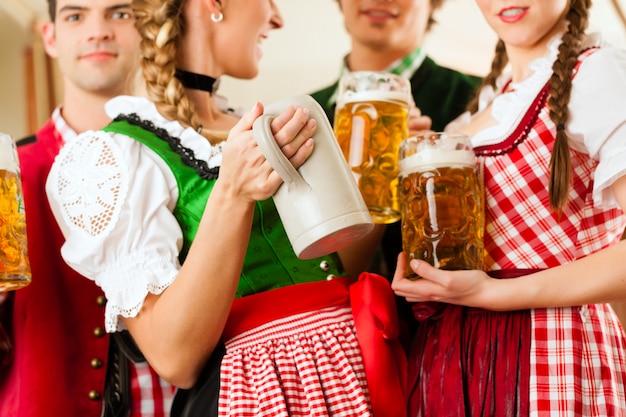 Young people in traditional Bavarian Tracht in restaurant or pub