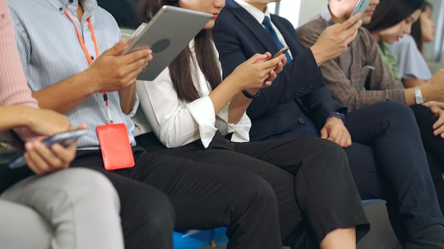 Young people using mobile phone in public underground train . Urban city lifestyle and commuting in Asia concept .