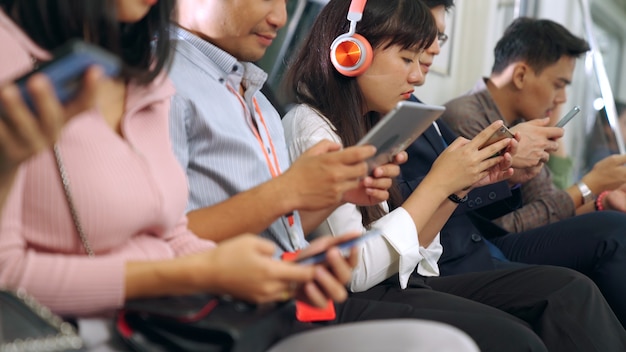 Young people using mobile phone in subway