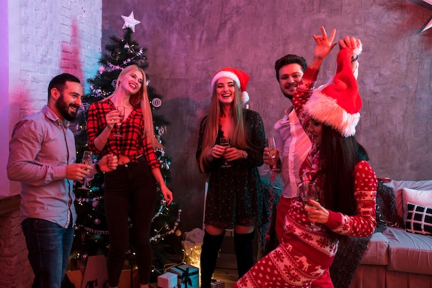 Young people with glasses of champagne at Christmas party