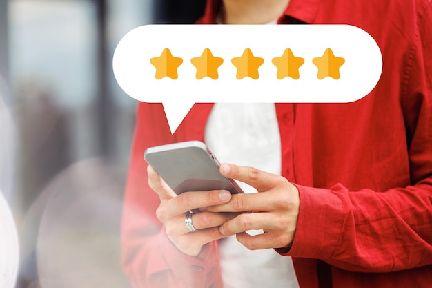 Young person giving a 5 star rating on mobile phone