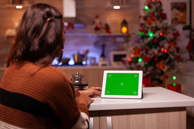 Young person watching green screen technology on tablet