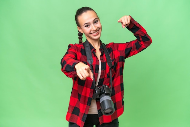 Young photographer Arab woman over isolated background points finger at you while smiling