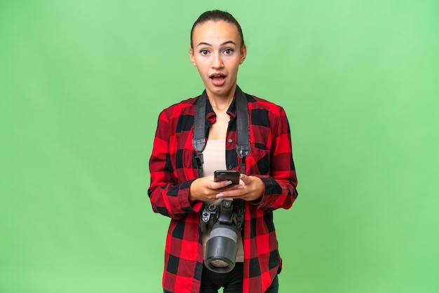 Young photographer Arab woman over isolated background surprised and sending a message