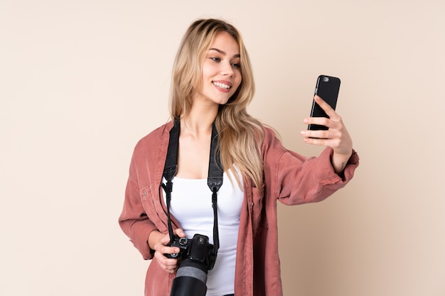 Young photographer girl over isolated