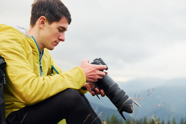 Young photographer makes photos Majestic Carpathian Mountains Beautiful landscape of untouched nature