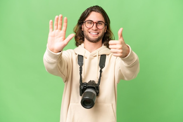 Young photographer man over isolated background counting six with fingers