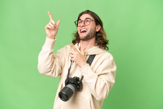 Young photographer man over isolated background pointing with the index finger a great idea