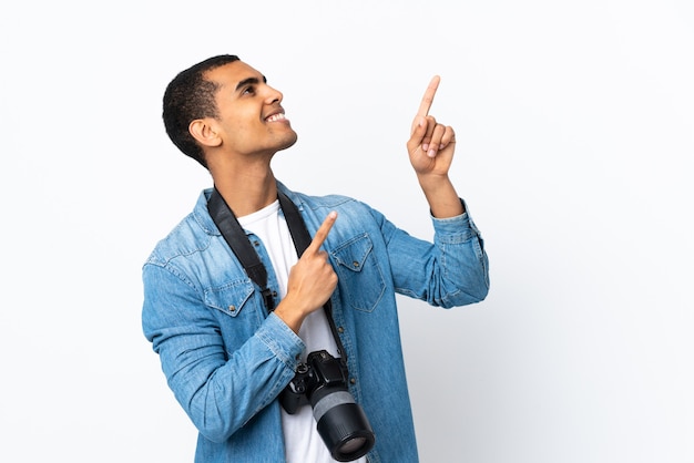 Young photographer man over isolated white wall pointing with the index finger a great idea