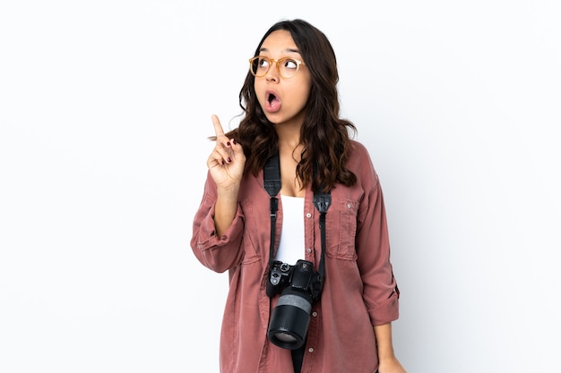 Young photographer woman over isolated white thinking an idea pointing the finger up