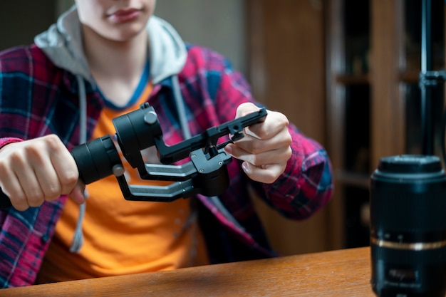 Young photographic equipment repair master in a workshop