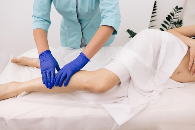 Young physiotherapist worker woman assisting physical medical exercise recovery