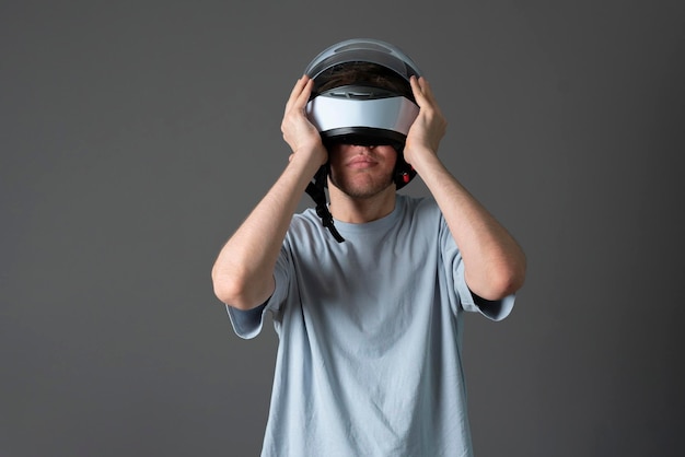 A young pilot driver put on white protective racing helmet