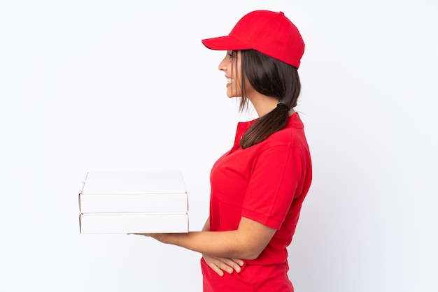 Young Pizza delivery woman isolated in lateral position