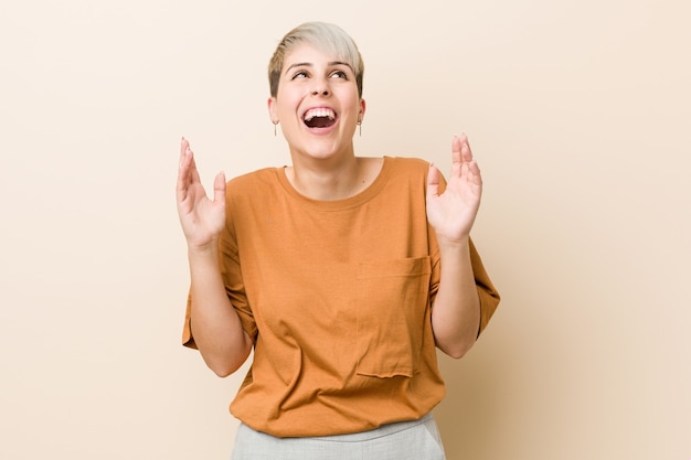 Young plus size woman with short hair joyful laughing a lot. Happiness concept.