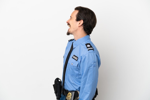 Young police man over isolated background white laughing in lateral position