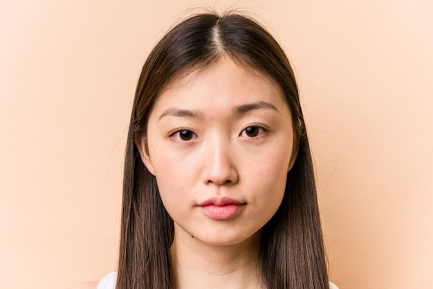 Young portrait asian woman isolated on beige background