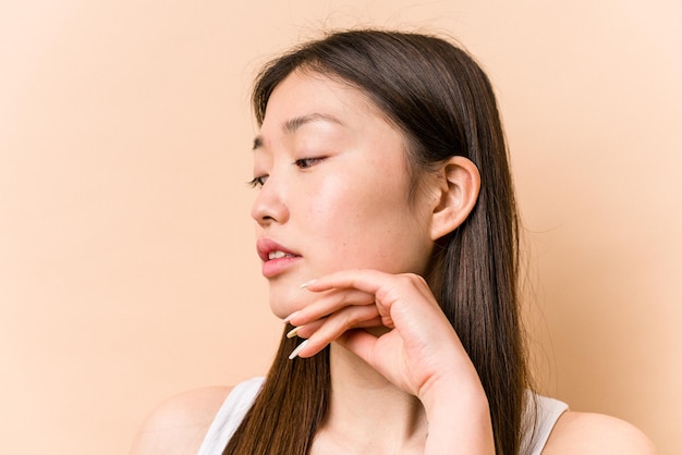 Young portrait asian woman isolated on beige background