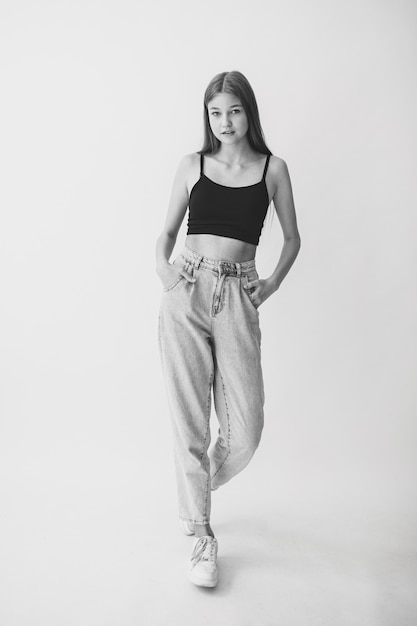 Young positive girl on a white background. Black and White.