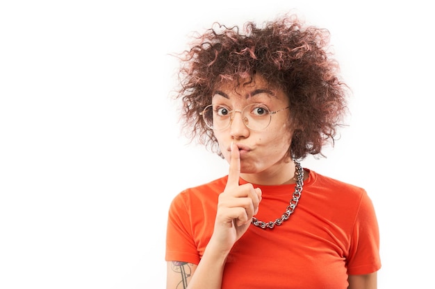 Young positive kazakh girl with afro hairstyle put finger on lips shh keep silence and secret isolated on white background