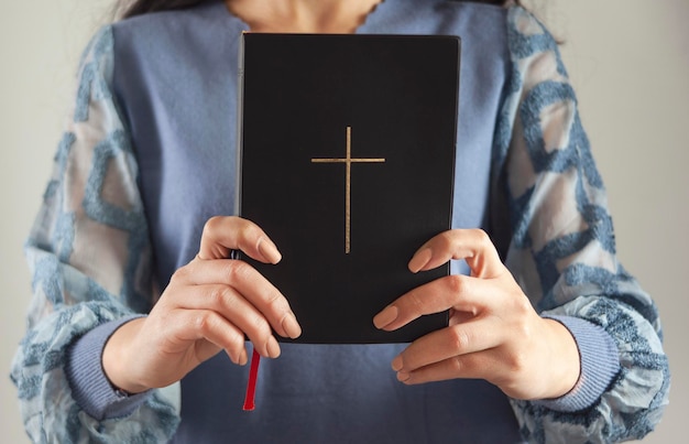 Young prayer woman holding Bible