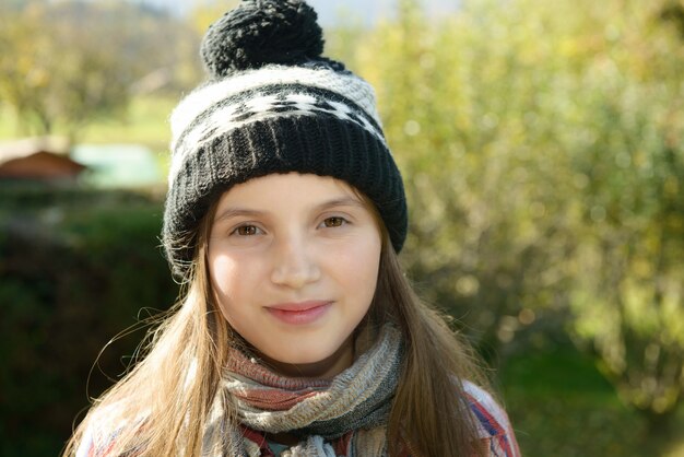 Young pre teen with a winter cap, outdoors