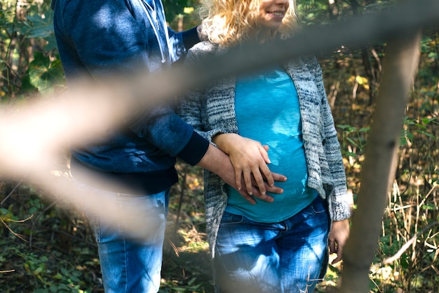 Young pregnant couple in the park