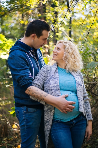 Young pregnant couple in the park