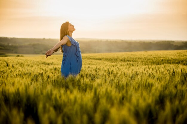 Young pregnant woman in the field