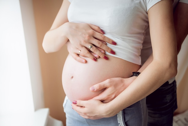 Young pregnant woman and her husband.