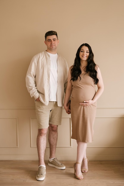 Young pregnant woman with husband at home happy family and pregnancy concept