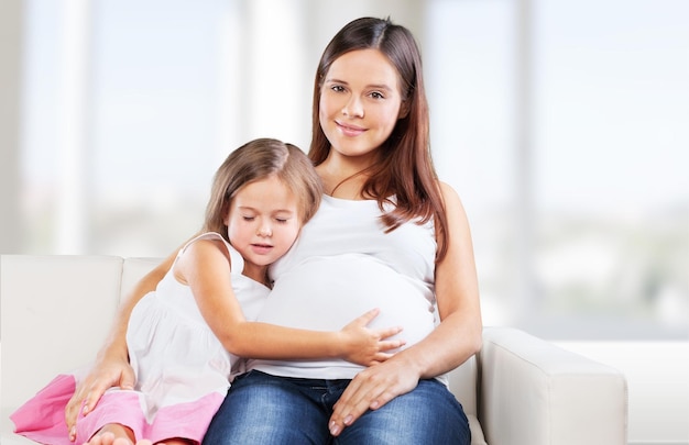 Young pregnant woman with little girl