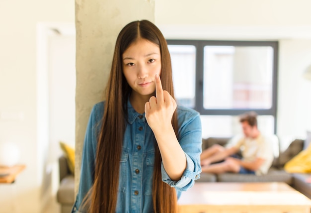 Young pretty asian woman feeling angry